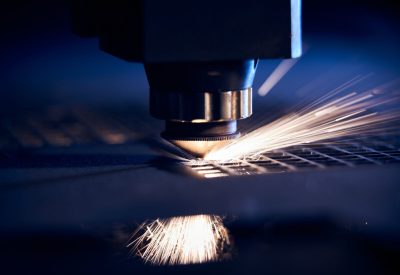 CNC Laser cutting of metal close up, modern industrial technology. Small depth of field